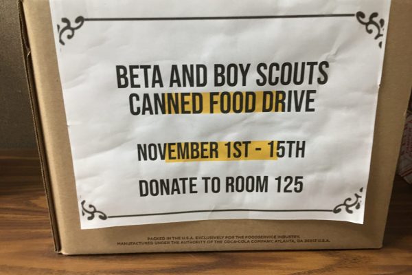 A donation box collecting canned goods for a food drive.